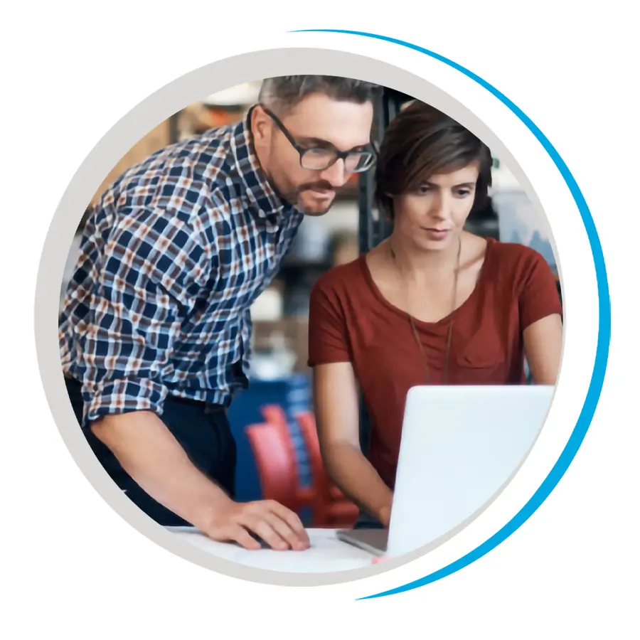 A male and female co-work intently study a laptop screen
